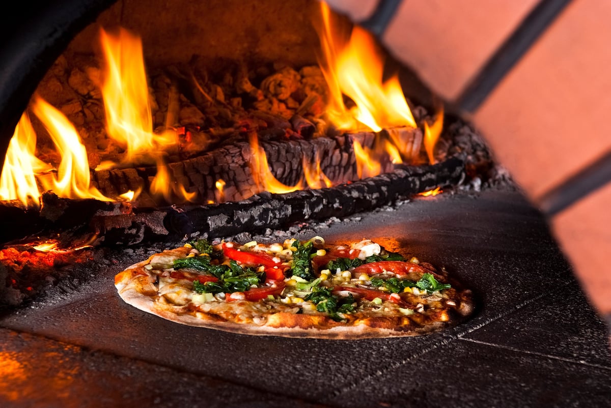 Pizza baking in a brick pizza oven