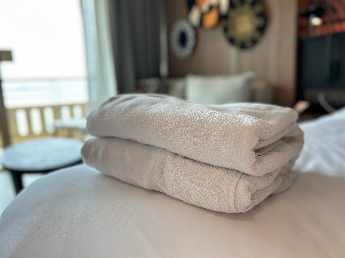 Luxury white bed linen and towels on a hotel bed
